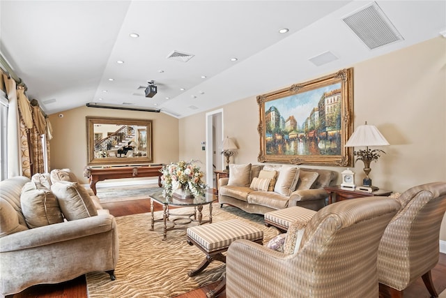 living room with wood-type flooring and vaulted ceiling