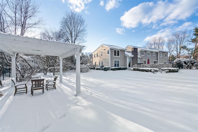 snowy yard with a pergola