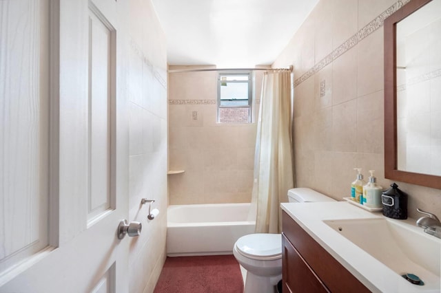 full bathroom with vanity, toilet, shower / bath combo with shower curtain, and tile walls