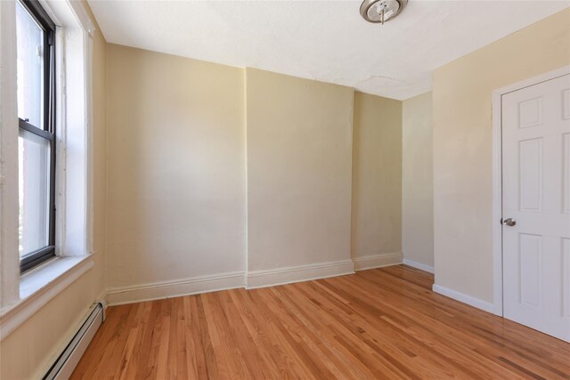 spare room featuring light hardwood / wood-style flooring and a baseboard radiator