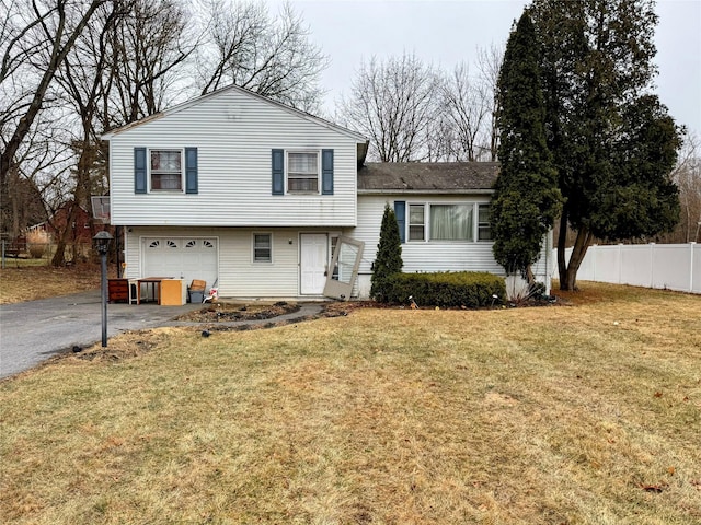 tri-level home with a front yard and a garage