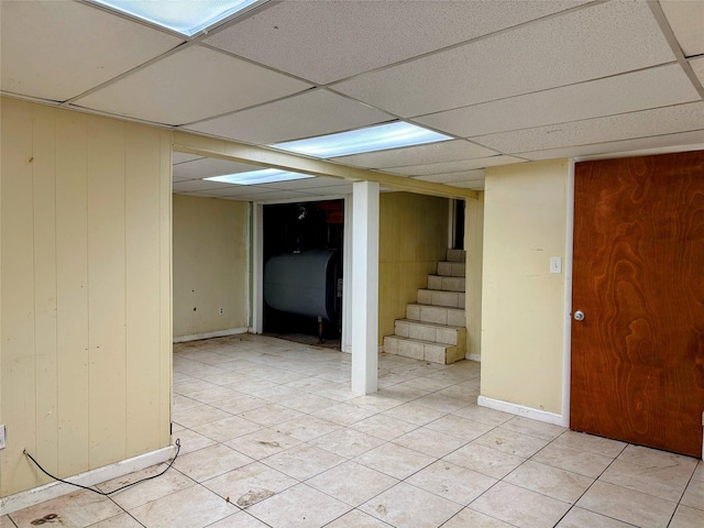 basement featuring a paneled ceiling