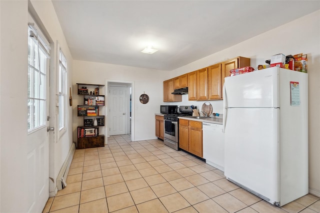 kitchen featuring baseboard heating, light tile patterned flooring, and white appliances