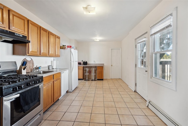 kitchen with dishwasher, light tile patterned flooring, sink, stainless steel gas range, and a baseboard radiator