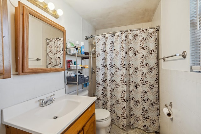 bathroom featuring toilet, vanity, tile walls, and walk in shower