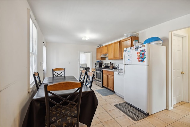 kitchen with light tile patterned flooring and white appliances