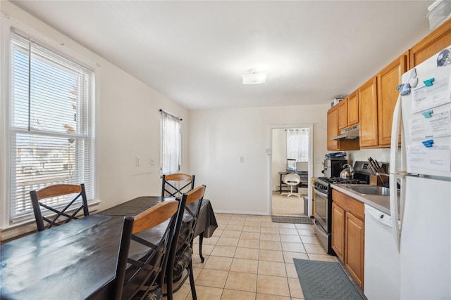 kitchen featuring light tile patterned floors and white appliances