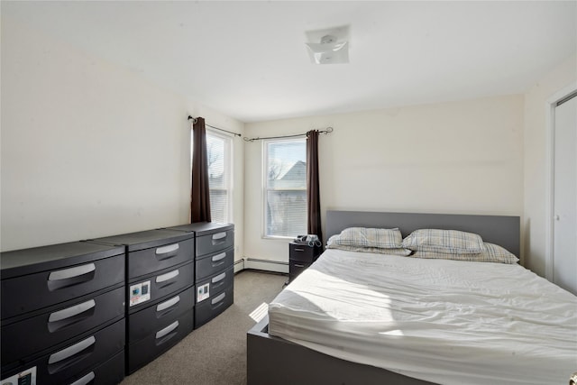 carpeted bedroom with a baseboard heating unit