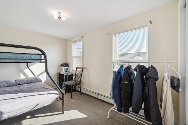 bedroom with carpet floors, multiple windows, and a baseboard heating unit