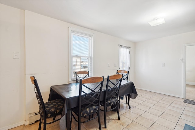 tiled dining space with a baseboard radiator