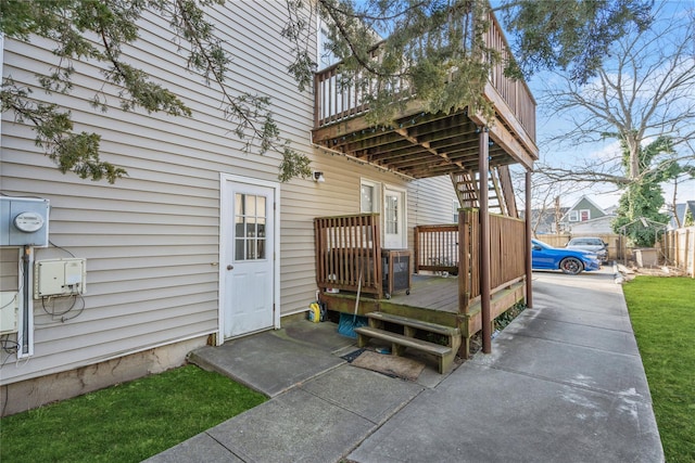 view of exterior entry with a wooden deck