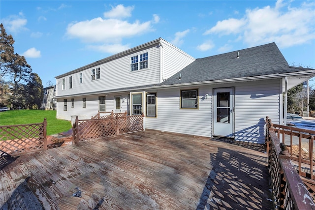 back of house with a lawn and a wooden deck