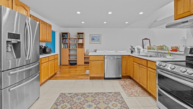 kitchen featuring kitchen peninsula, appliances with stainless steel finishes, extractor fan, sink, and light tile patterned floors