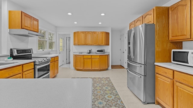 kitchen with light tile patterned floors and appliances with stainless steel finishes