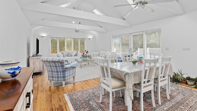 dining space featuring vaulted ceiling with beams, light hardwood / wood-style floors, and ceiling fan