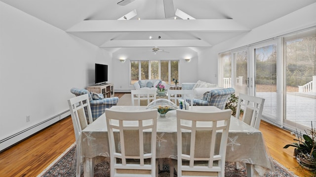 dining room featuring vaulted ceiling with beams, a baseboard radiator, light hardwood / wood-style flooring, and ceiling fan