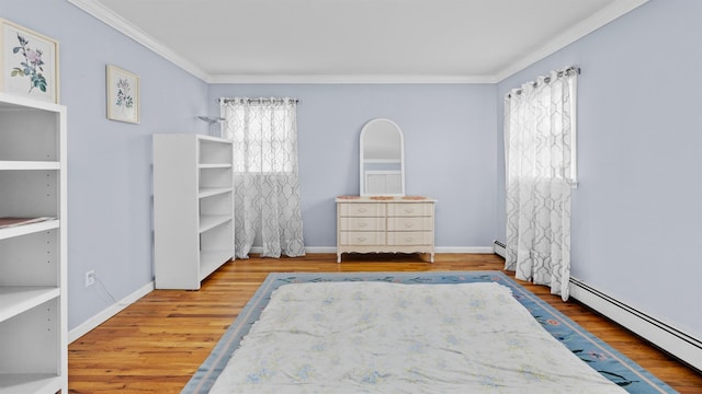 unfurnished bedroom featuring hardwood / wood-style floors, crown molding, and a baseboard heating unit