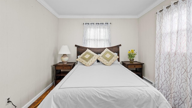 bedroom featuring hardwood / wood-style flooring, crown molding, and a baseboard radiator