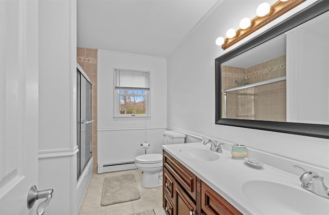 full bathroom with bath / shower combo with glass door, vanity, baseboard heating, tile patterned flooring, and toilet