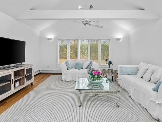 living area featuring lofted ceiling with beams, a healthy amount of sunlight, ceiling fan, and wood finished floors