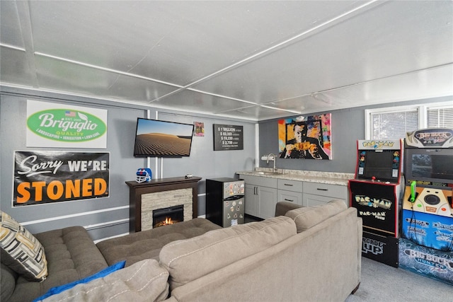 living room featuring a fireplace and sink