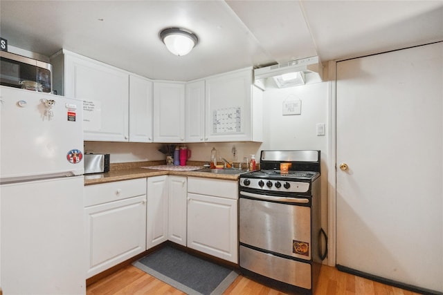 kitchen featuring stainless steel appliances, sink, exhaust hood, light hardwood / wood-style floors, and white cabinetry