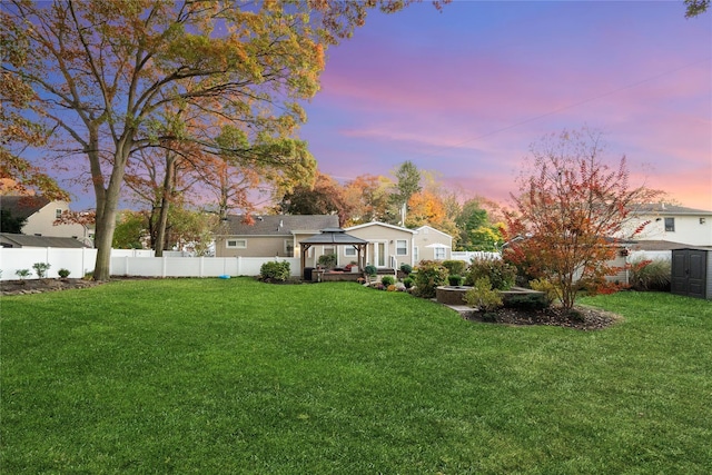 yard at dusk with a gazebo