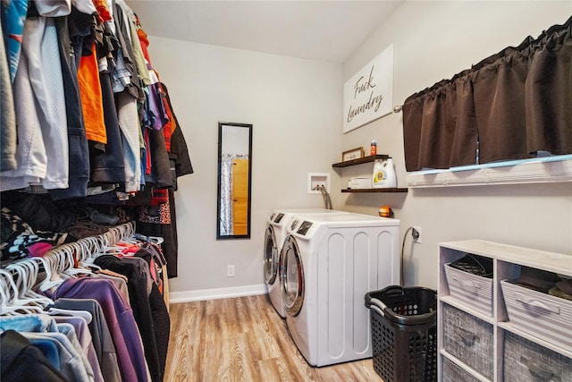 washroom featuring separate washer and dryer and light hardwood / wood-style flooring