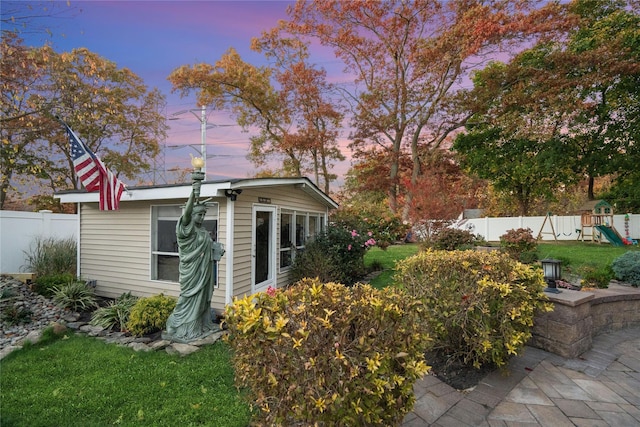 exterior space featuring an outbuilding, a playground, and a yard