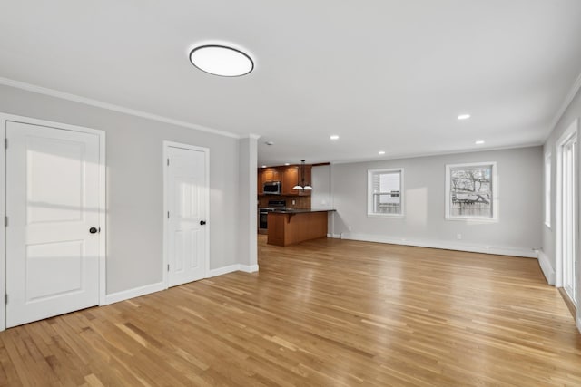 unfurnished living room with ornamental molding and light hardwood / wood-style flooring