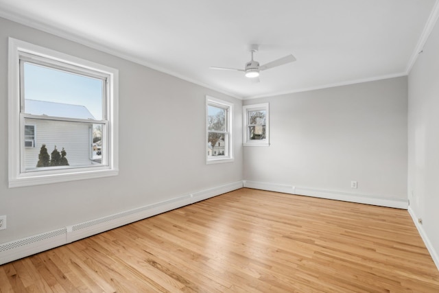 unfurnished room featuring ornamental molding, plenty of natural light, and light hardwood / wood-style floors