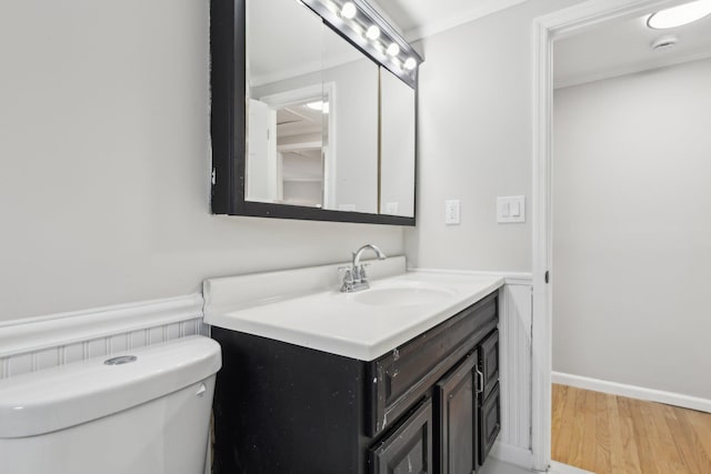 bathroom featuring crown molding, vanity, toilet, and hardwood / wood-style floors