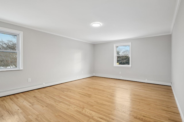 spare room with crown molding and light hardwood / wood-style floors