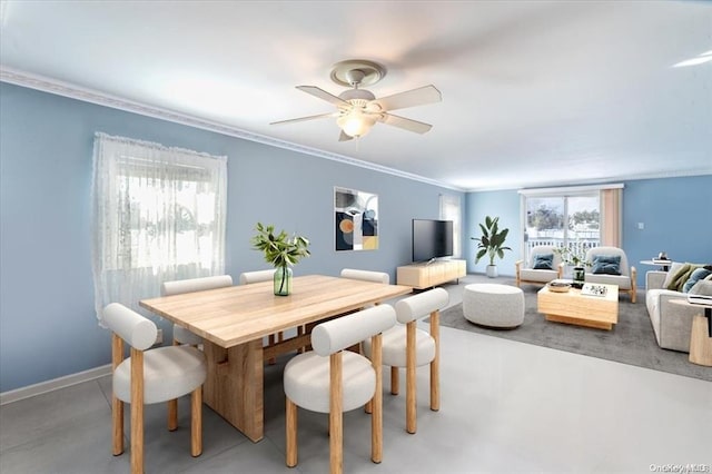 dining space with a healthy amount of sunlight, ceiling fan, and ornamental molding