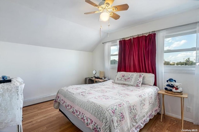 bedroom featuring ceiling fan, wood-type flooring, baseboard heating, and vaulted ceiling