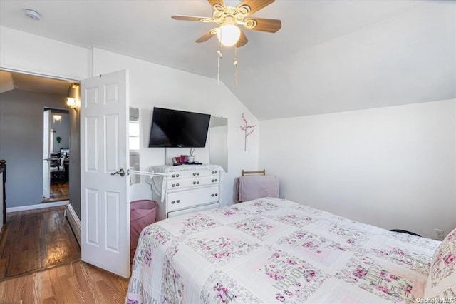 bedroom with vaulted ceiling, light hardwood / wood-style flooring, and ceiling fan