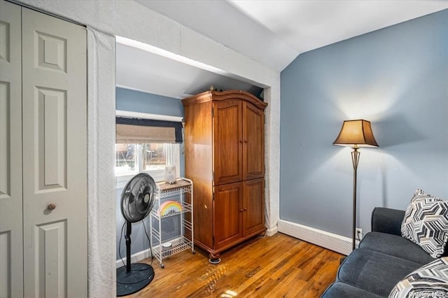 interior space with hardwood / wood-style flooring and vaulted ceiling