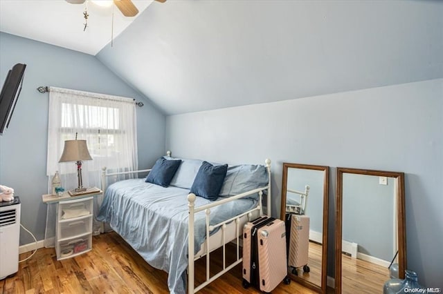 bedroom featuring ceiling fan, vaulted ceiling, and hardwood / wood-style flooring