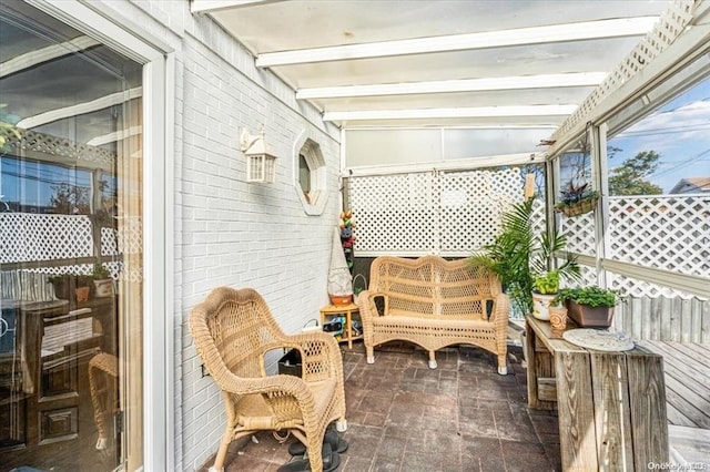 sunroom / solarium featuring beamed ceiling