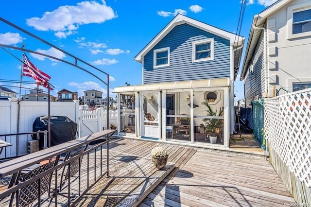 wooden terrace featuring a grill