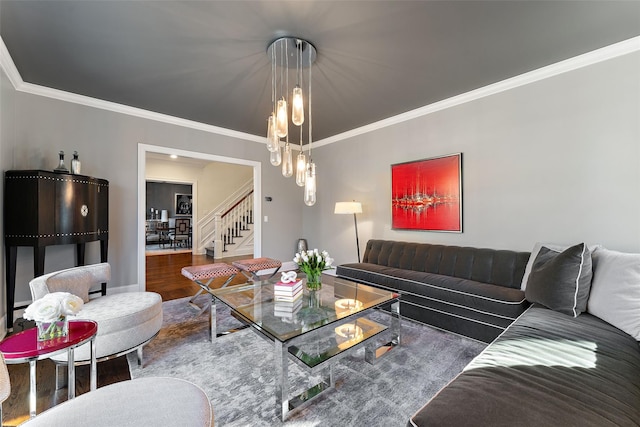 living room featuring a chandelier, crown molding, and hardwood / wood-style flooring