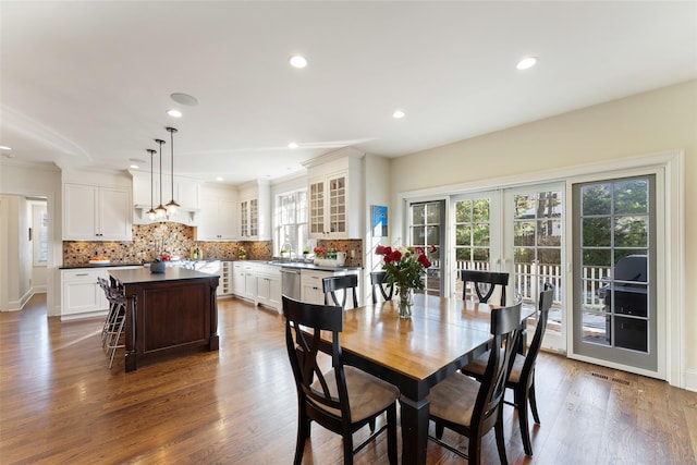 dining space featuring sink, dark hardwood / wood-style floors, french doors, and a healthy amount of sunlight