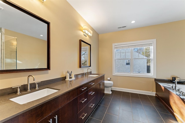 bathroom with toilet, tile patterned floors, and vanity