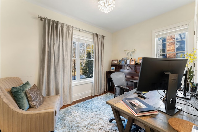 office area with hardwood / wood-style floors and a notable chandelier