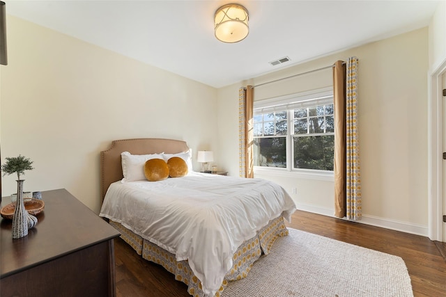 bedroom with dark wood-type flooring