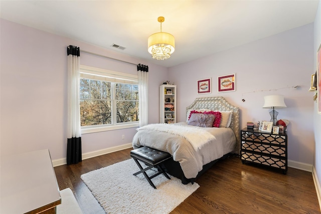 bedroom with dark hardwood / wood-style flooring