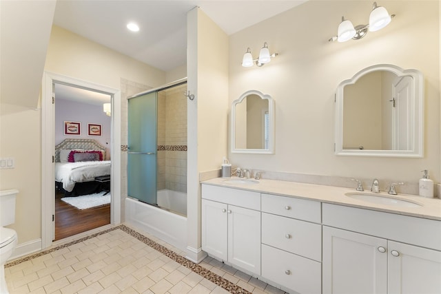 full bathroom featuring bath / shower combo with glass door, tile patterned floors, vanity, and toilet