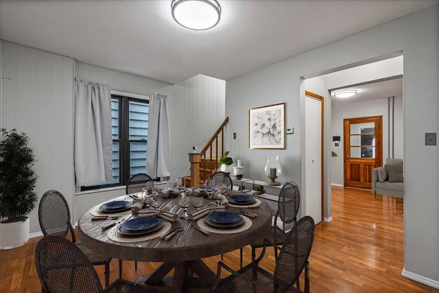 dining room featuring wood walls and hardwood / wood-style floors