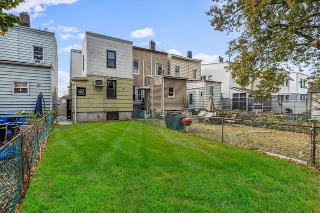 back of house with a lawn