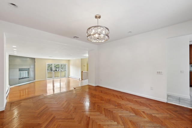 unfurnished living room featuring light parquet flooring, a baseboard heating unit, and an inviting chandelier